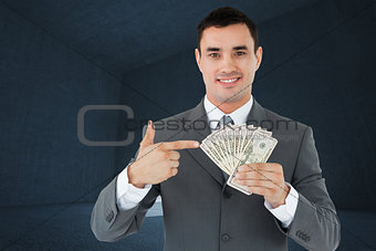 Composite image of businessman pointing at bank notes in his hand
