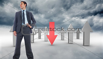 Composite image of happy businessman with hand on hip