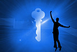 Composite image of glowing key on blue background