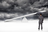Composite image of rear view of classy businessman holding grey umbrella