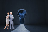 Composite image of serious businessman standing back to back with a woman