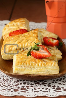 dessert patties puff pastry with strawberries on wooden table