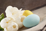 pastel color easter eggs with tulips on table