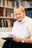 senior woman using touch pad device