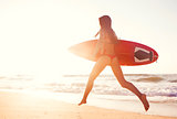 Hot surfer girl at sunset