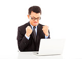  businessman feeling angry and make a fist with laptop