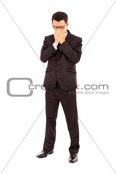 tired young businessman rubbing his eyes