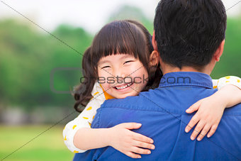 happy little girl hugging embracing her father
