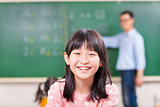 close-up pupils smiling in class with teacher