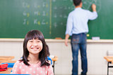 happy schoolchildren in class with teacher