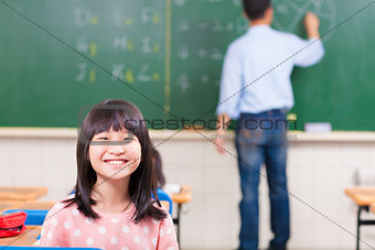 happy schoolchildren in class with teacher