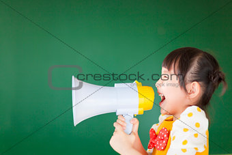 happy kid shouts something into the megaphone