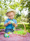 Cute Little Boy Enjoying His Easter Eggs Outside in Park