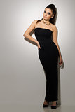 Vogue. Beautiful woman posing in black dress