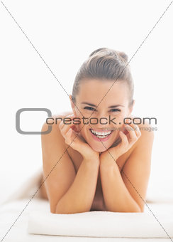 Portrait of smiling young woman on massage table
