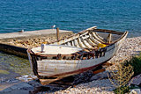 Old wooden boat broken by the sea