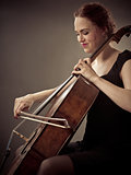 Smiling Cellist playing her old cello