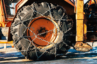Snow chains on tractor tire
