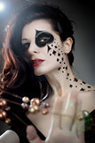 beautiful woman with make-up and body-art styled as playing card