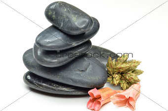 Stack of black stones with fake flowers