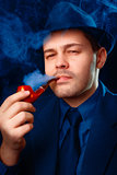 Man with Hat Smoking a Pipe Close Up