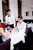 waiter serve fresh espresso for happy couple 