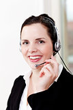 smiling young female call center agent with headset