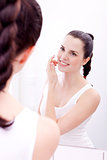 applying cream on face skincare