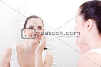 applying cream on face skincare