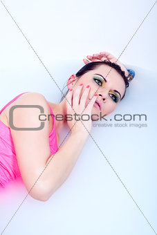 beautiful young woman with colorful makeup in water