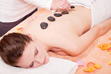 young attractive woman get hot stone massage 