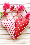 colorful handmade fabric hearts on a wooden background