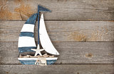 Toy sailboat on a wooden background