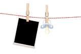 Instant photo and pacifier hanging on the clothesline