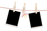 Instant photo frames and pacifier hanging on the clothesline