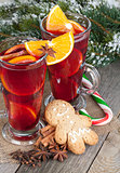 Christmas mulled wine with spices, gingerbread and snowy fir tre