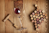 Red wine glass, corkscrew and grape shaped corks