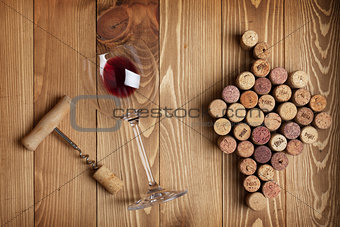 Red wine glass, corkscrew and grape shaped corks