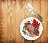 Sirloin steak with rosemary and cherry tomatoes on a plate