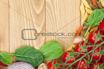 Fresh ingredients for cooking: pasta, tomato, salad and spices