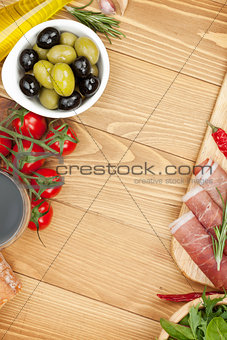 Red wine with olives, tomatoes, prosciutto, bread and spices