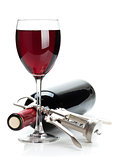 Red wine glass, bottle and corkscrew