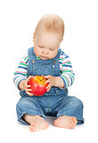 Small baby boy holding an apple
