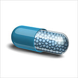 Medical blue capsule with granules on white background.