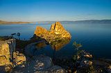 Shaman Rock in the rays of the rising sun. Olkhon Island, Baikal