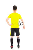 soccer player holding a soccer next to  waist