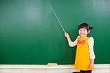 asian little girl using a baton to point on a blackboard