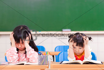 two sad girls doing in homework
