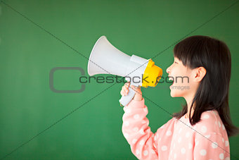 happy kid using a megaphone to shout