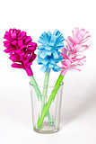 Bouquet of colored paper flowers in the faceted glass